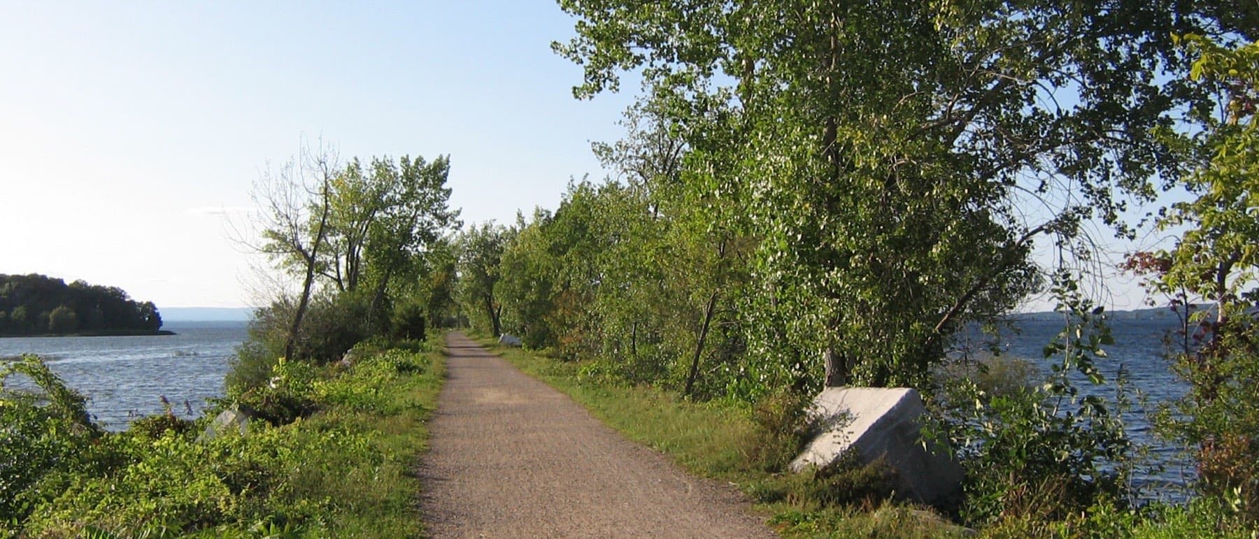 The Colchester Causeway path running out between the waters of Lake Champlain.