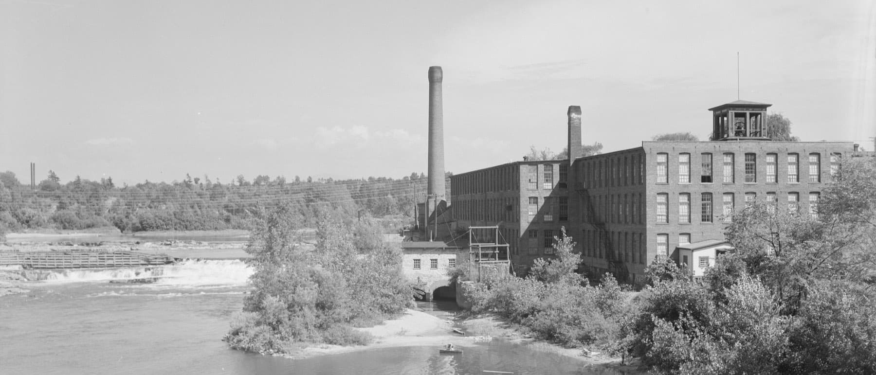 The Champlain Mill beside the falls on the Winooski River, photographed in the mid-twentieth century.
